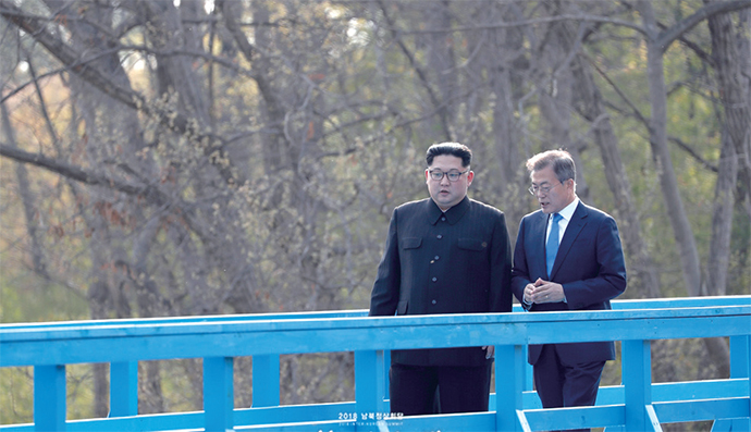 President Moon Jae-in and Chairman Kim Jong Un walking along a footbridge at the border village of Panmunjeom